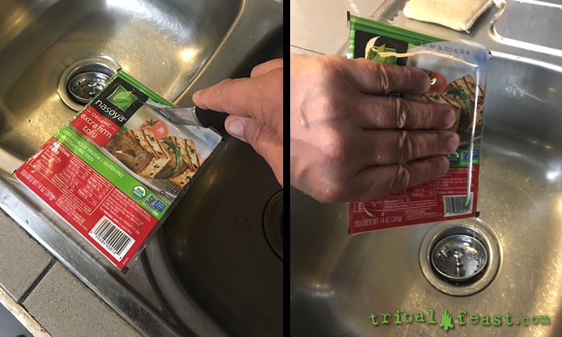 A quick and easy way to both drain and press out a bit of the water from the tofu is to press it in the package it came in.