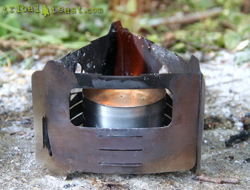 The Bushbox Ultralight Pocket Stove makes a great pot stand and windscreen for an alcohol stove like this beer can stove. 